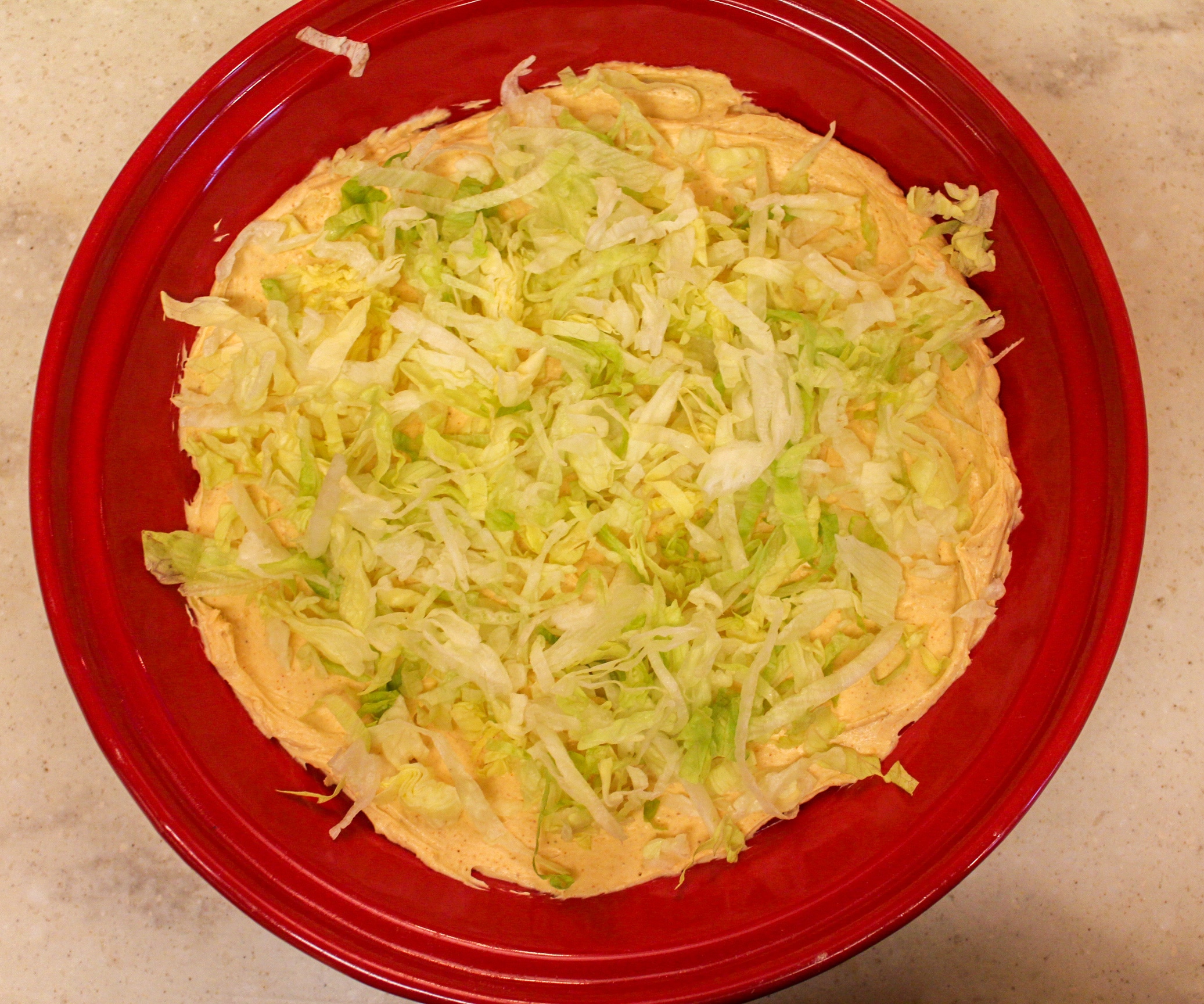 taco dip overhead shot in red plate