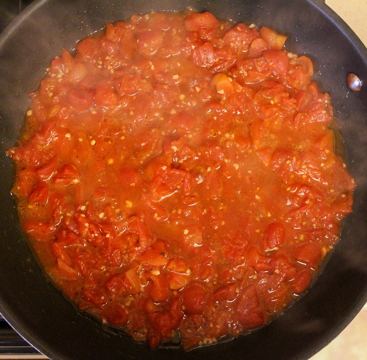 tomatoes cooking in skillet