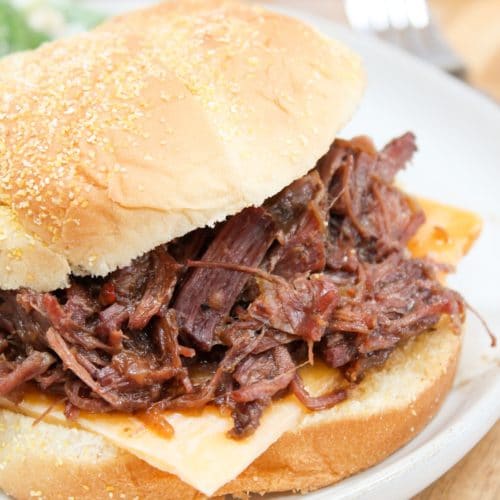 slow cooker hot beef sandwich on a white plate