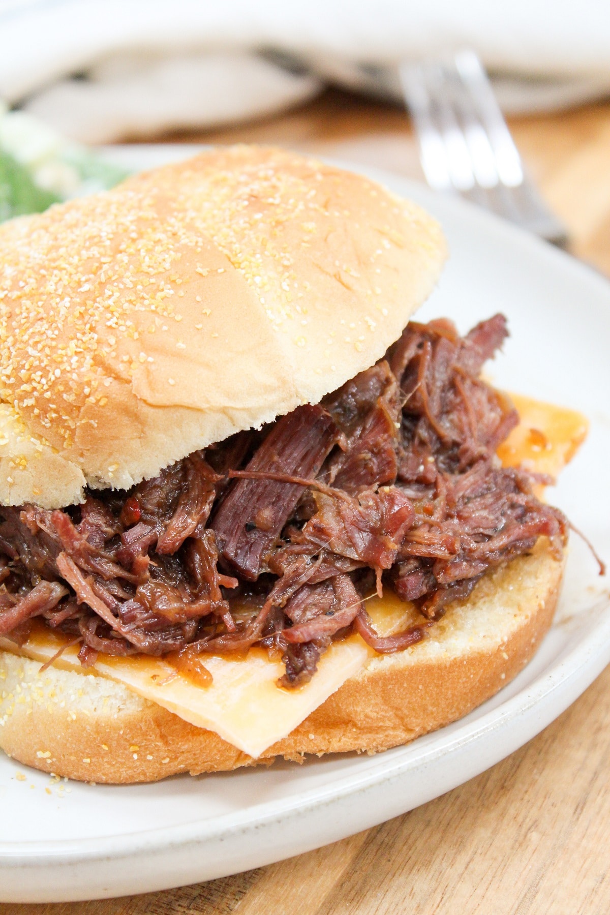 slow cooker hot beef sandwich on a white plate