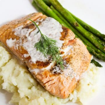 salmon with champagne sauce and dill on top