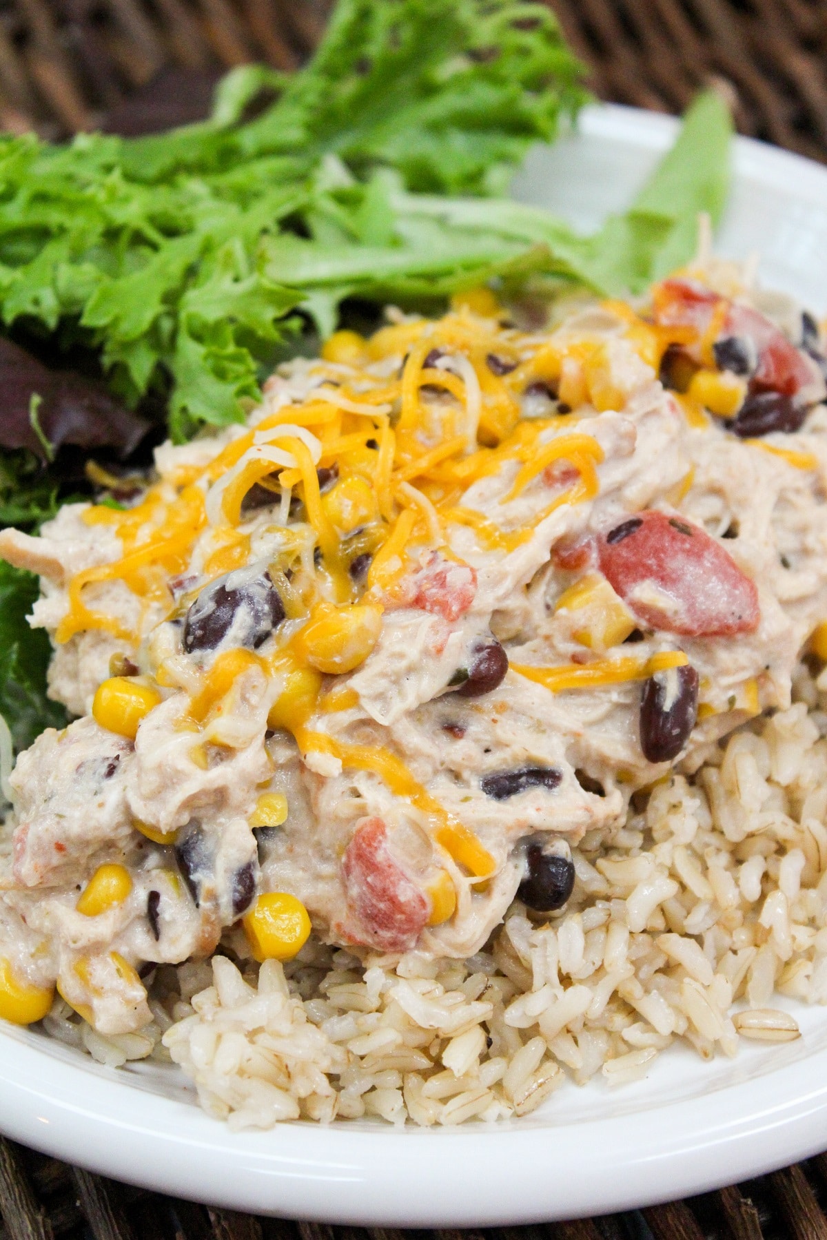 Slow Cooker Cream Cheese Chili Chicken plated over rice