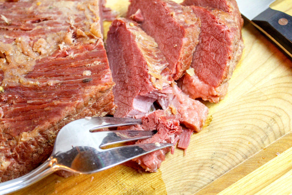 corned beef sliced on a cutting board