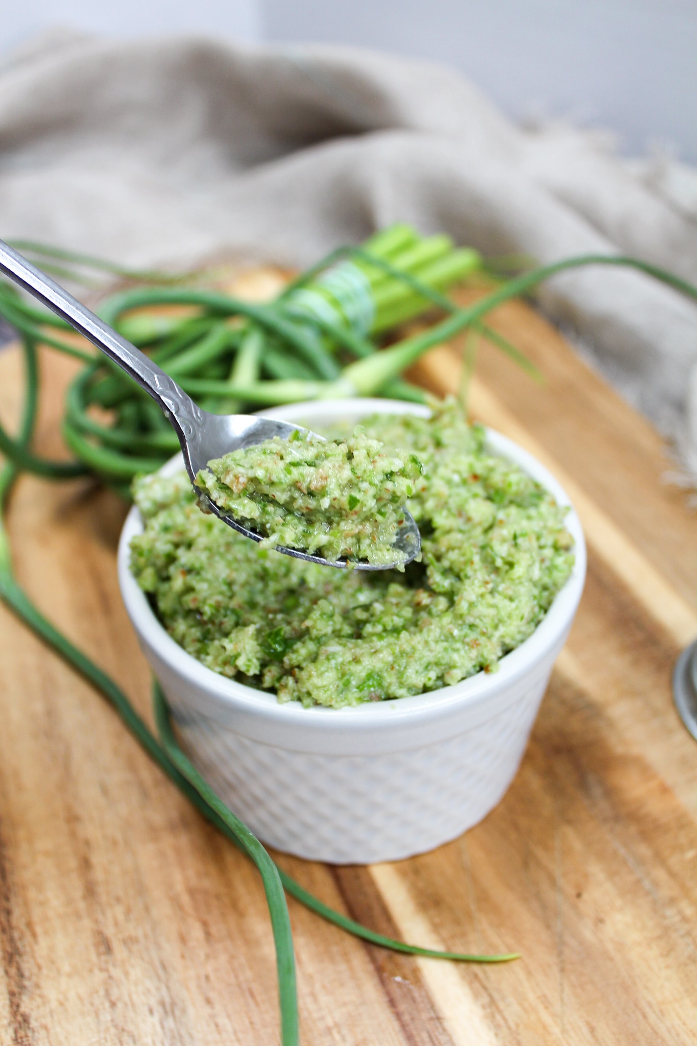 garlic scape pesto in a cup with a spoon