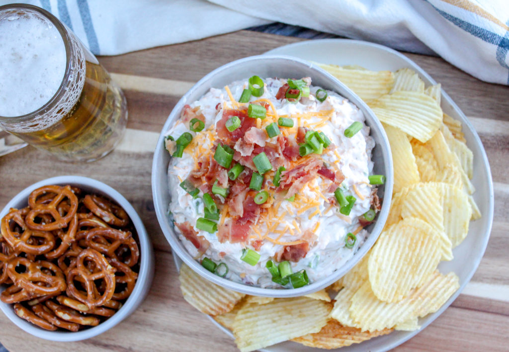beer dip in a bowl with chips and pretzels