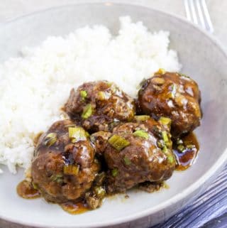 cooked meatballs in dish with rice