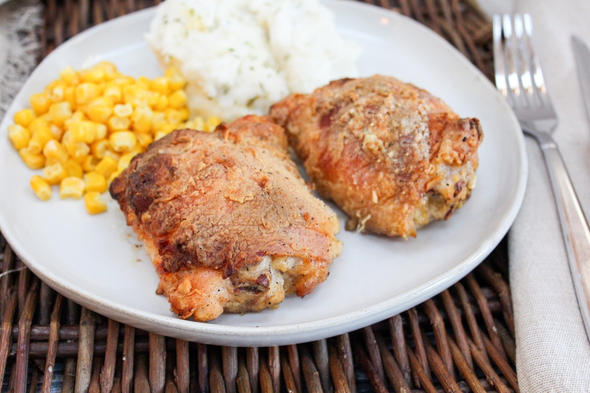 oven fried chicken on a plate with sides