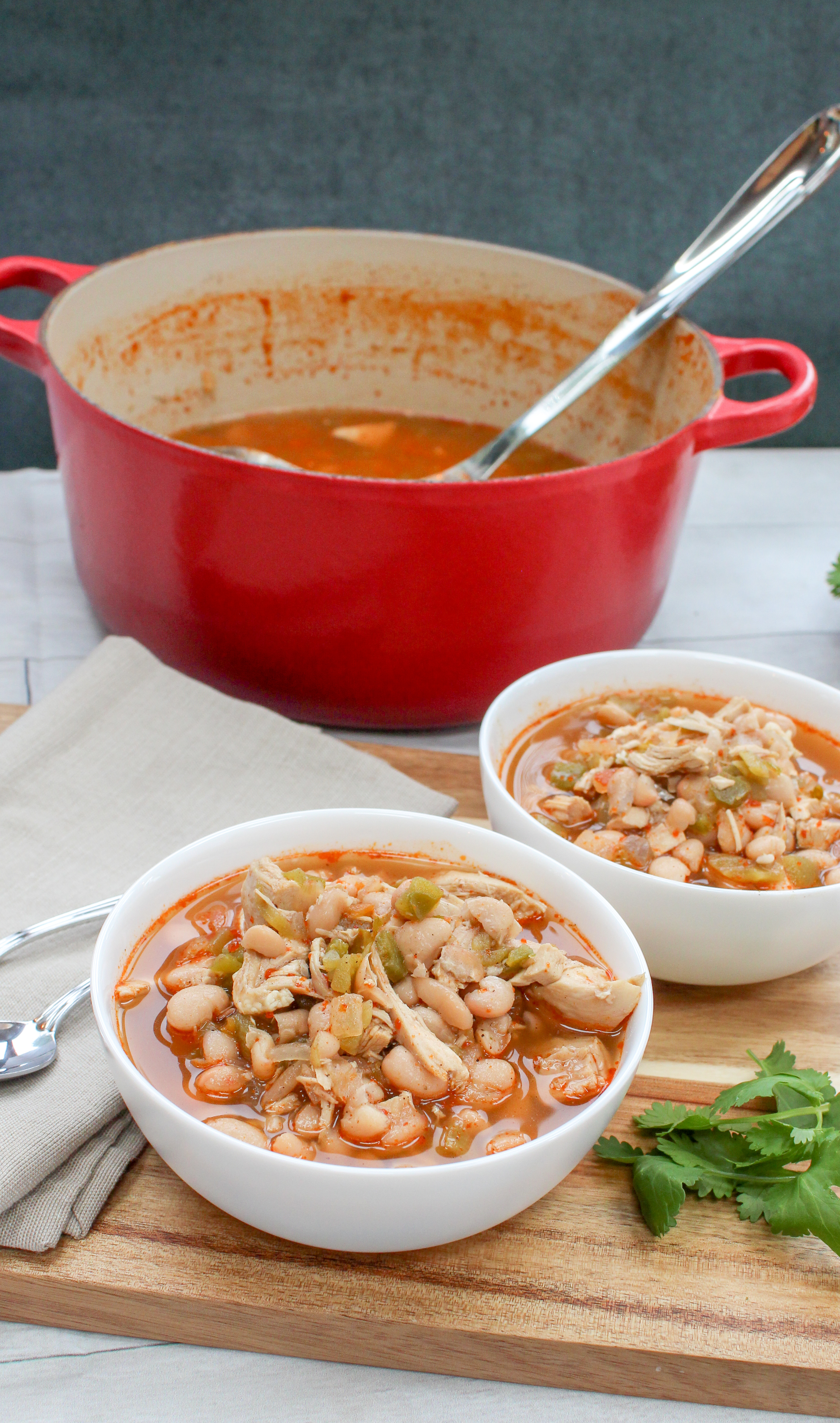 chicken, beans, and pepper soup in a white bowl