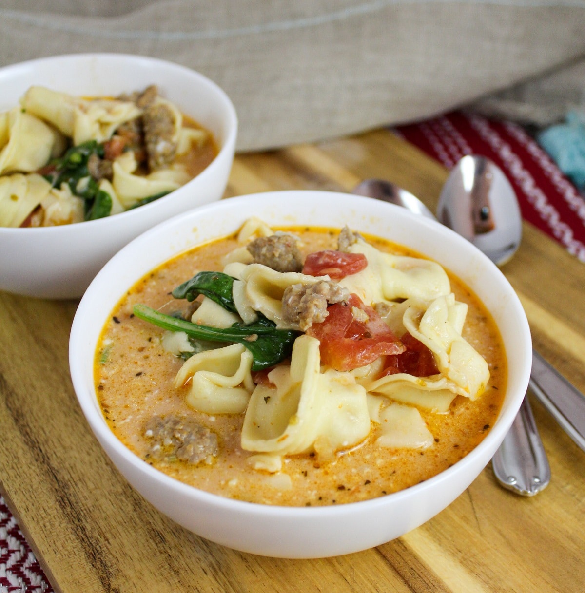 slow cooker tortellini and sausage soup i white bowls