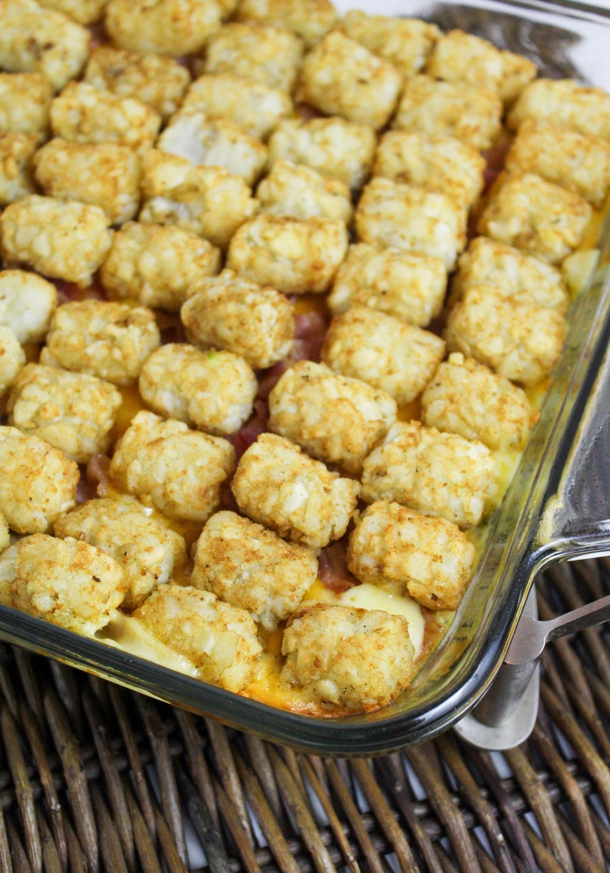 chicken bacon ranch tater tot casserole in a glass casserole dish