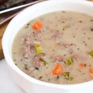 Creamy Wild Rice and Sausage Soup in a white bowl