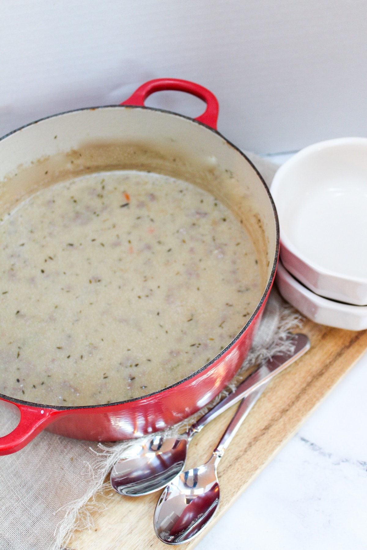 Creamy Wild Rice and Sausage Soup in a red soup pot