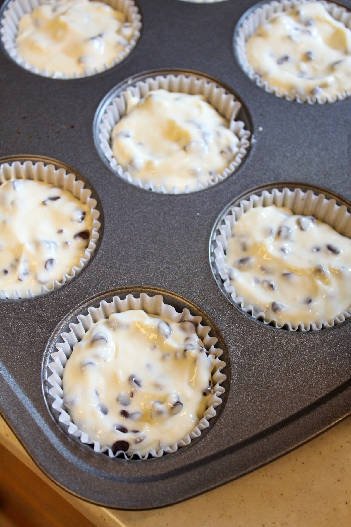 unbaked cheesecake in muffin tin