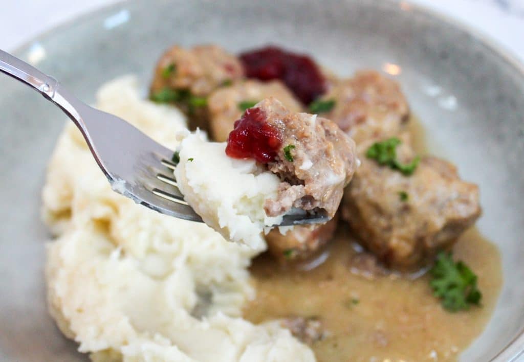 slow cooker swedish meatballs on a fork