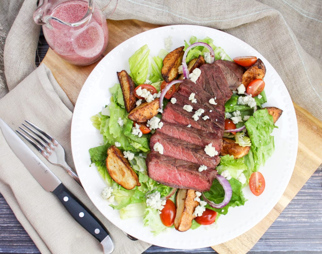 overhead picture of sliced steak on a salad
