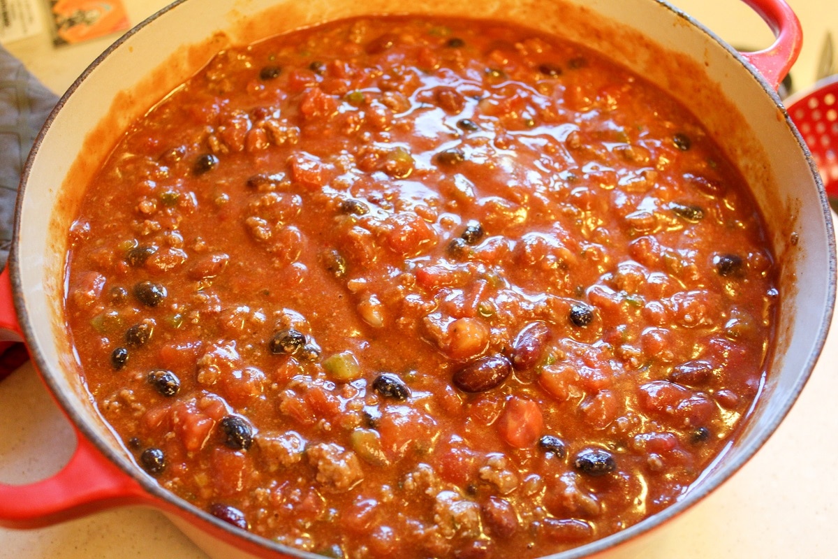 chili preparation in a pot with tomato sauce