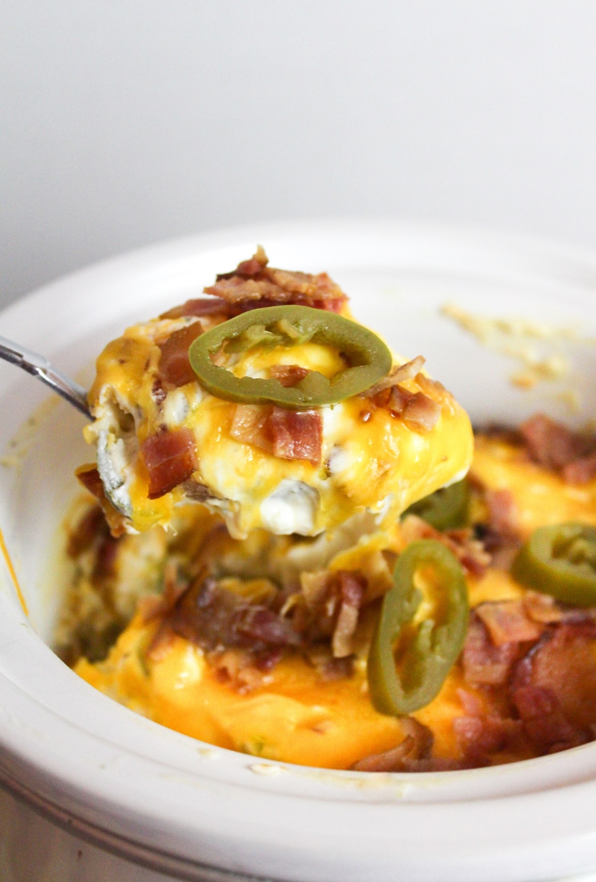 slow cooker jalapeno popper dip with spoon