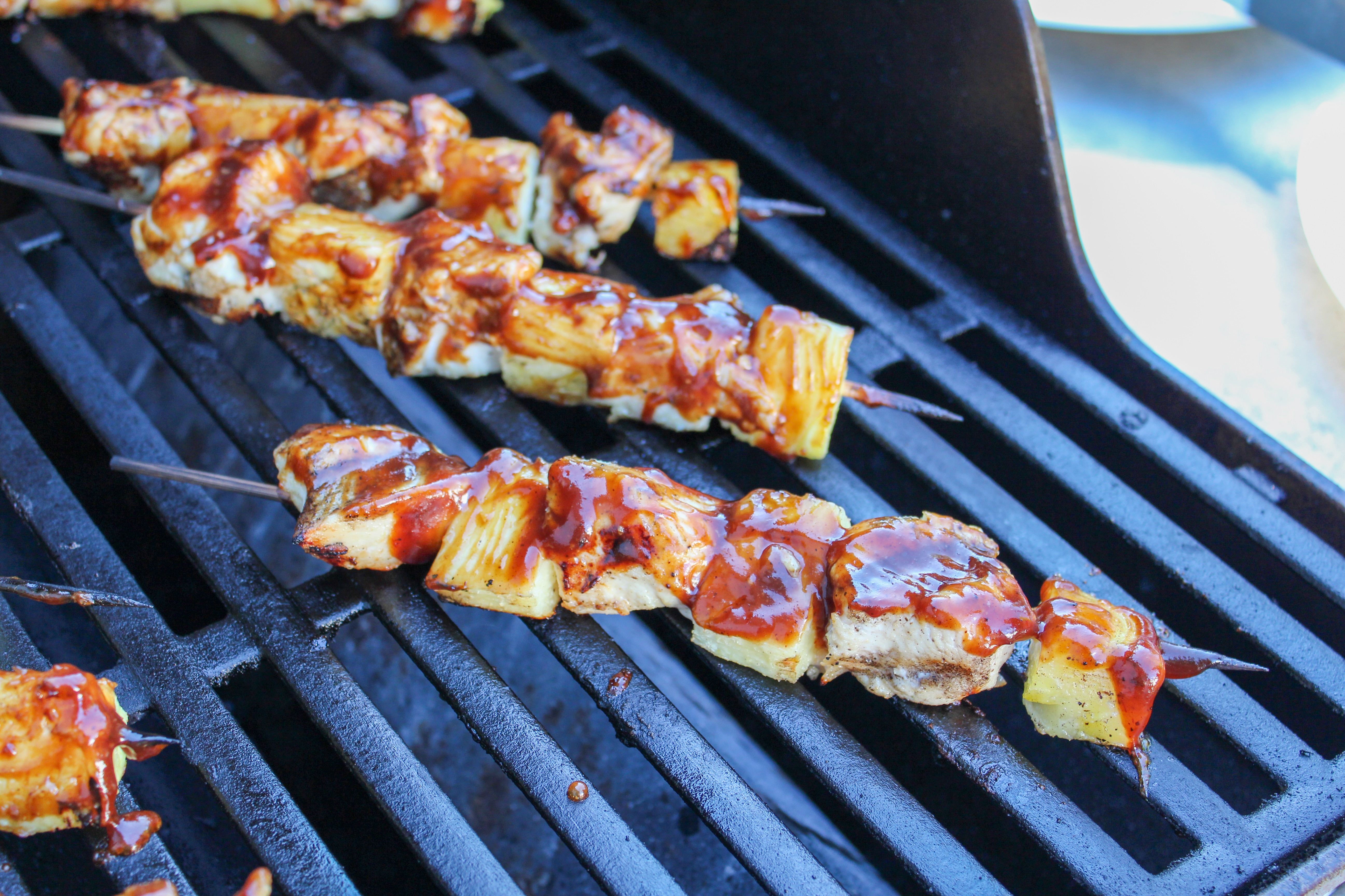 chicken pineapple with bbq sauce on a stick on the grill