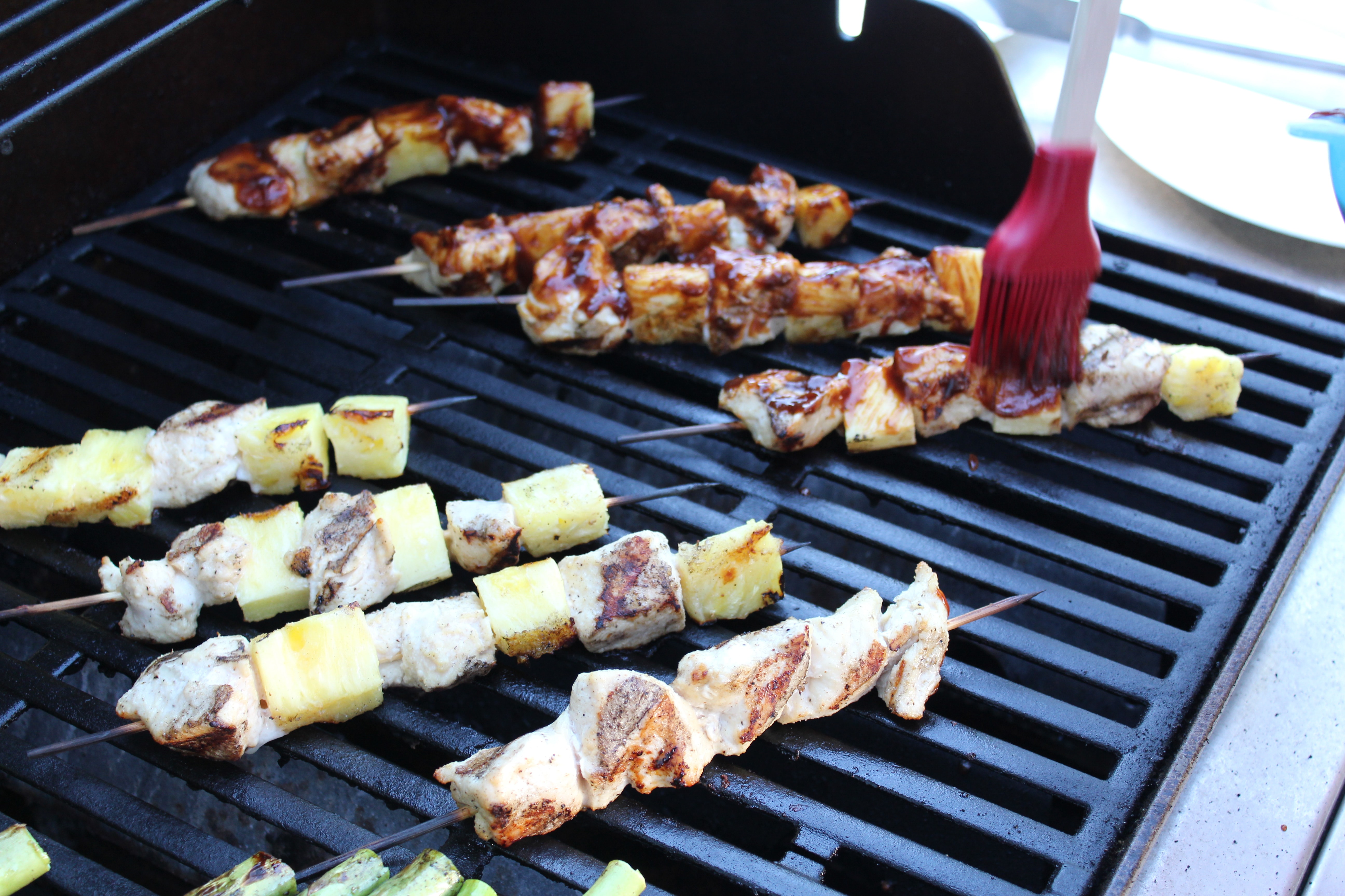 chicken pineapple with bbq sauce on a stick on the grill