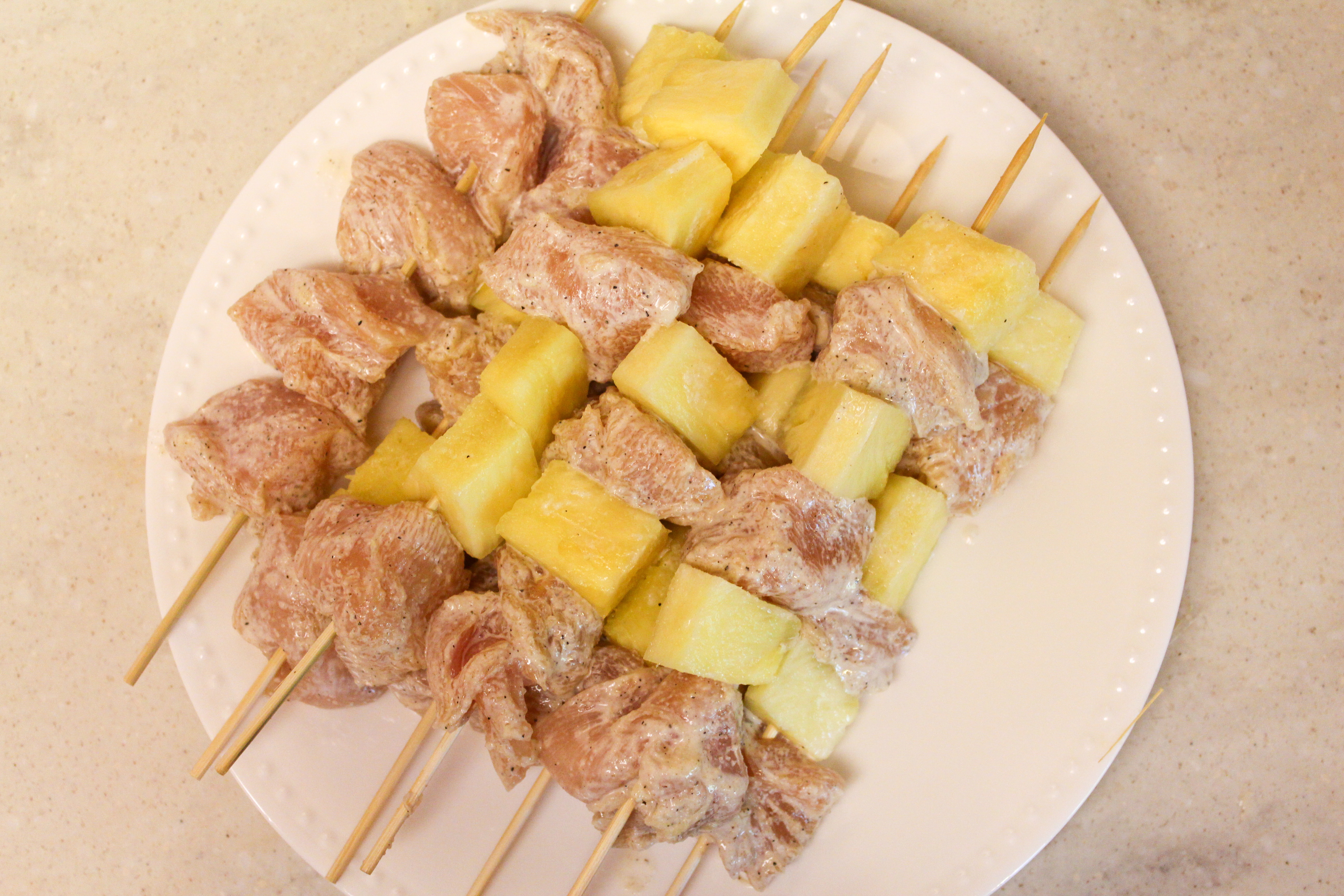 chicken pineapple uncooked without sauce on a stick