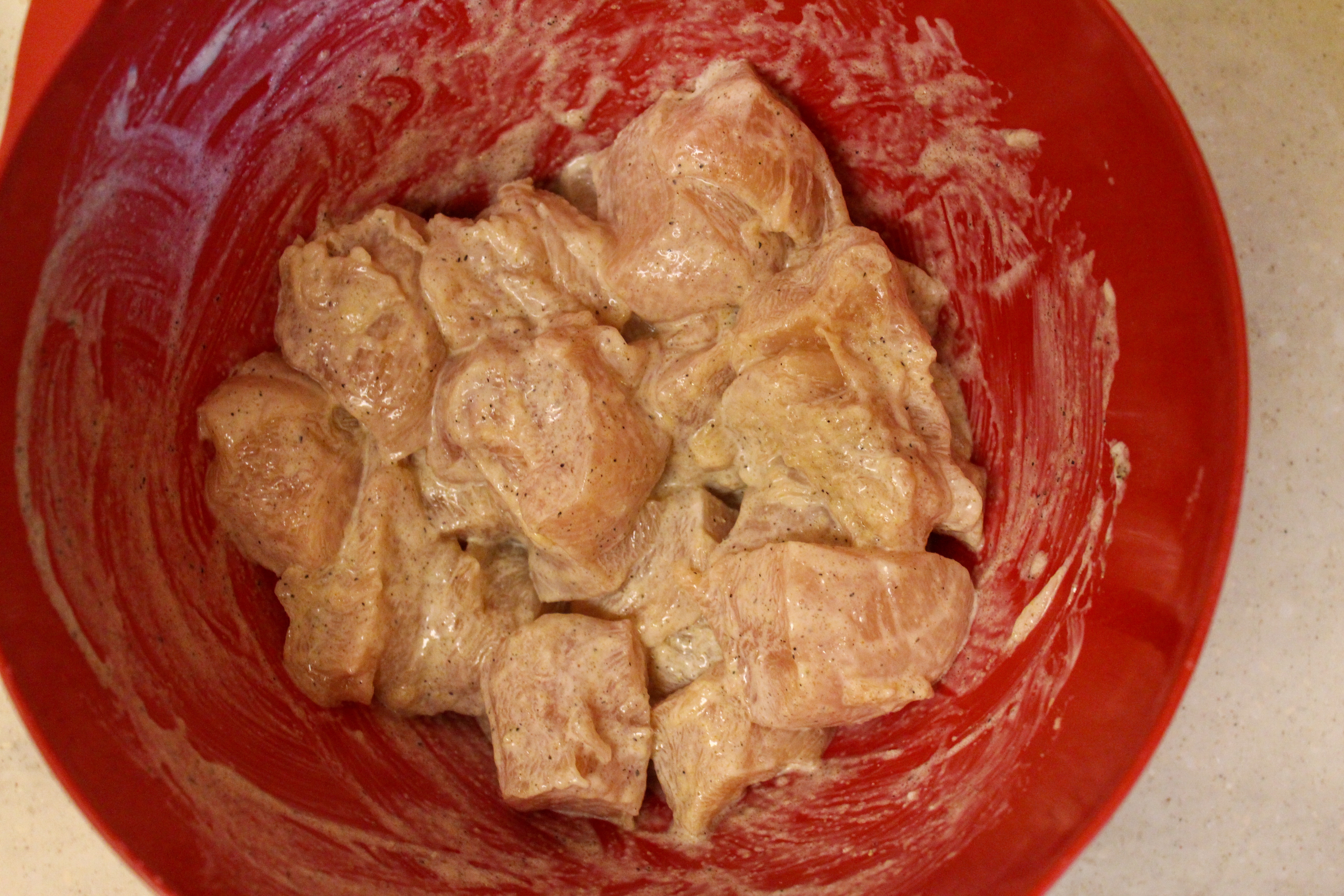 chicken in a bowl with mayo and seasonings