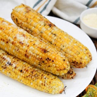 grilled corn stacked on a plate