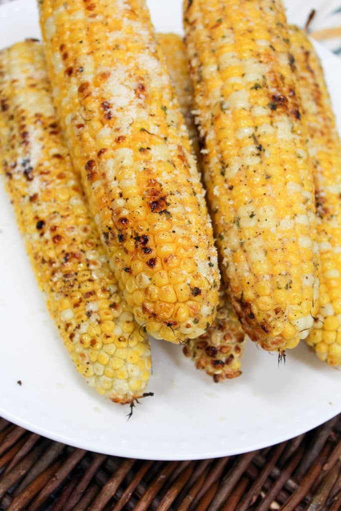 grilled corn stacked on a plate