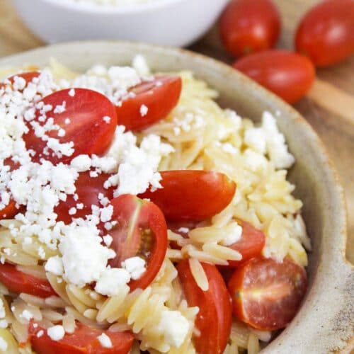 greek orzo with tomatoes and feta in a bowl