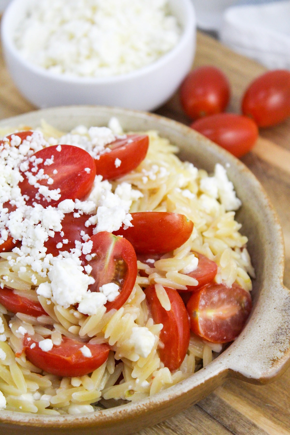 greek orzo with tomatoes and feta in a bowl