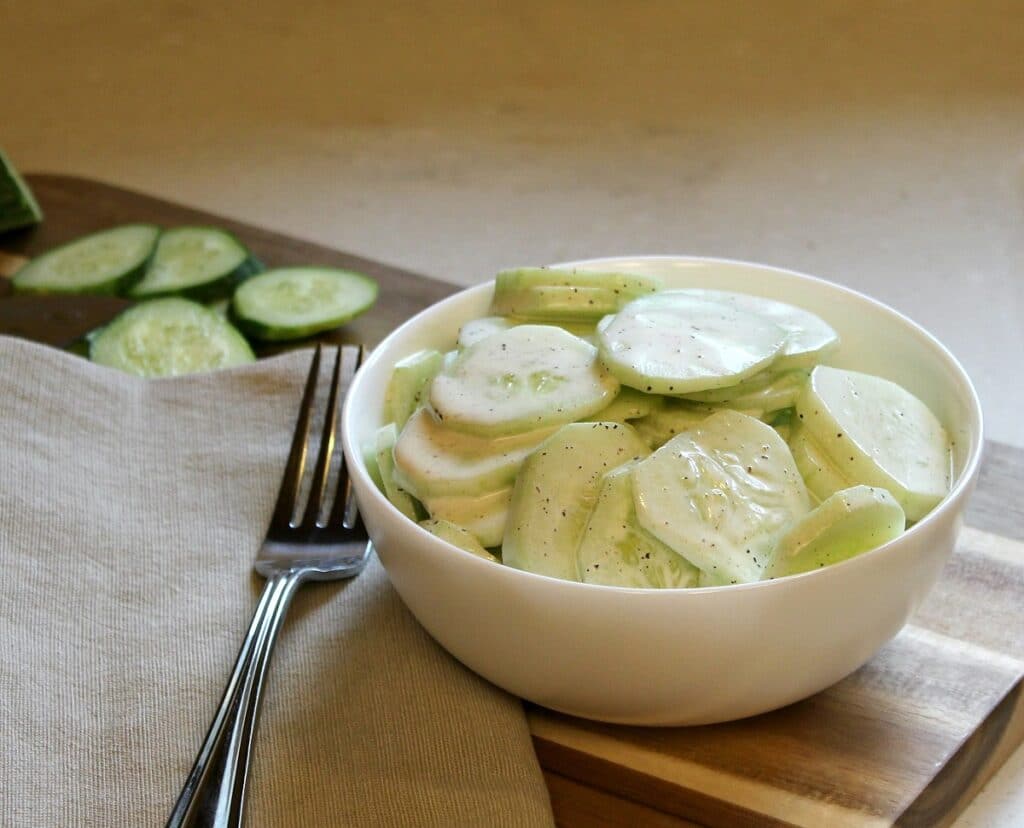creamy cucumbers in a white bowl