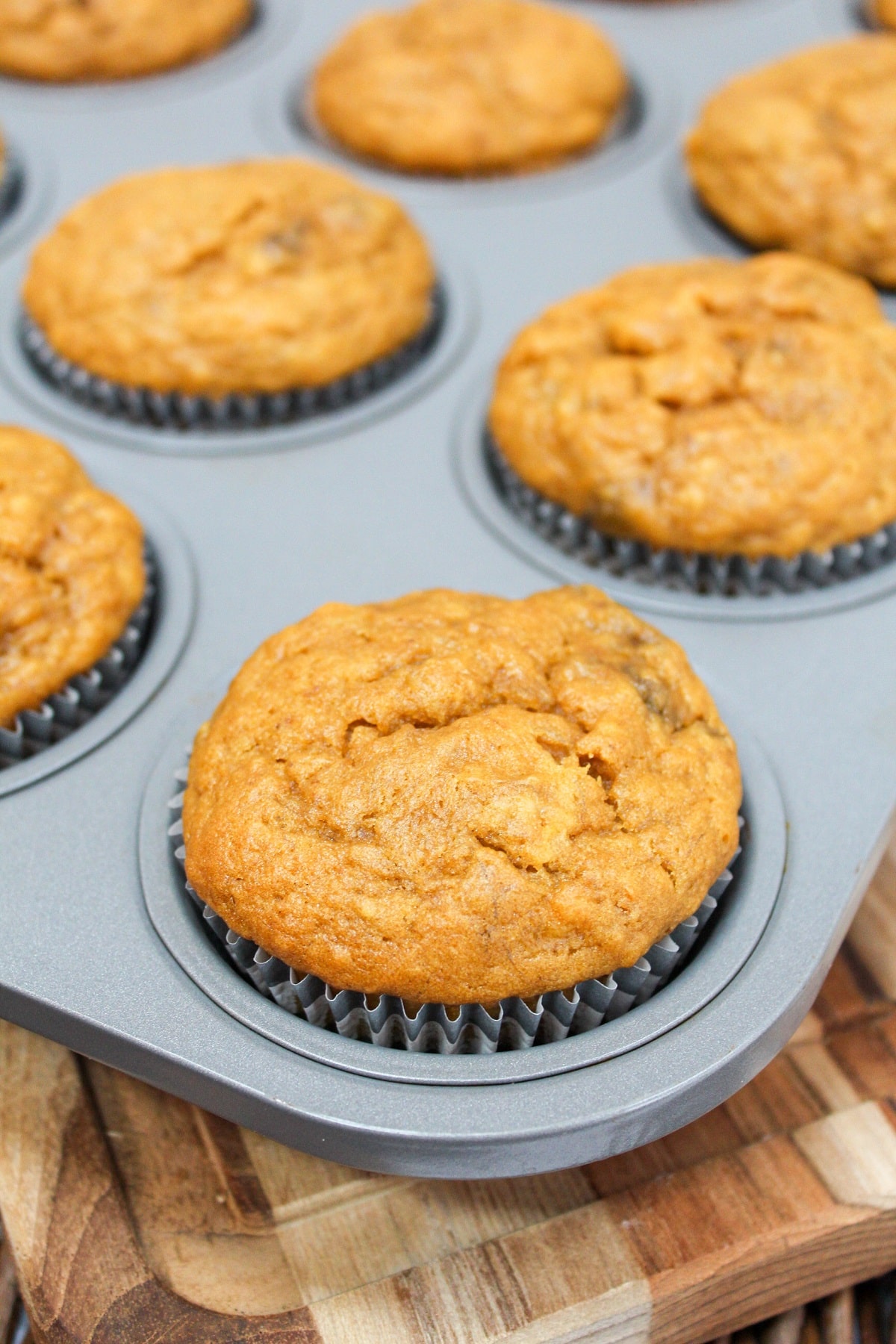 Baked muffins in a metal tin.