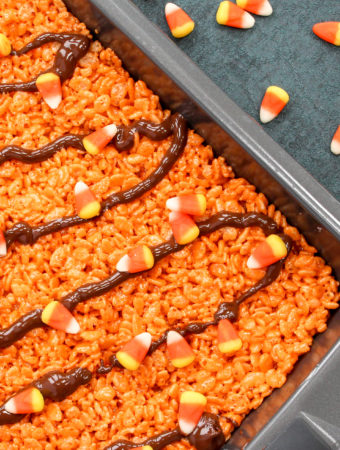 Rice Crispy Cereal pressed into a pan and cut into squares. Garnished with Candy Corn and Chocolate