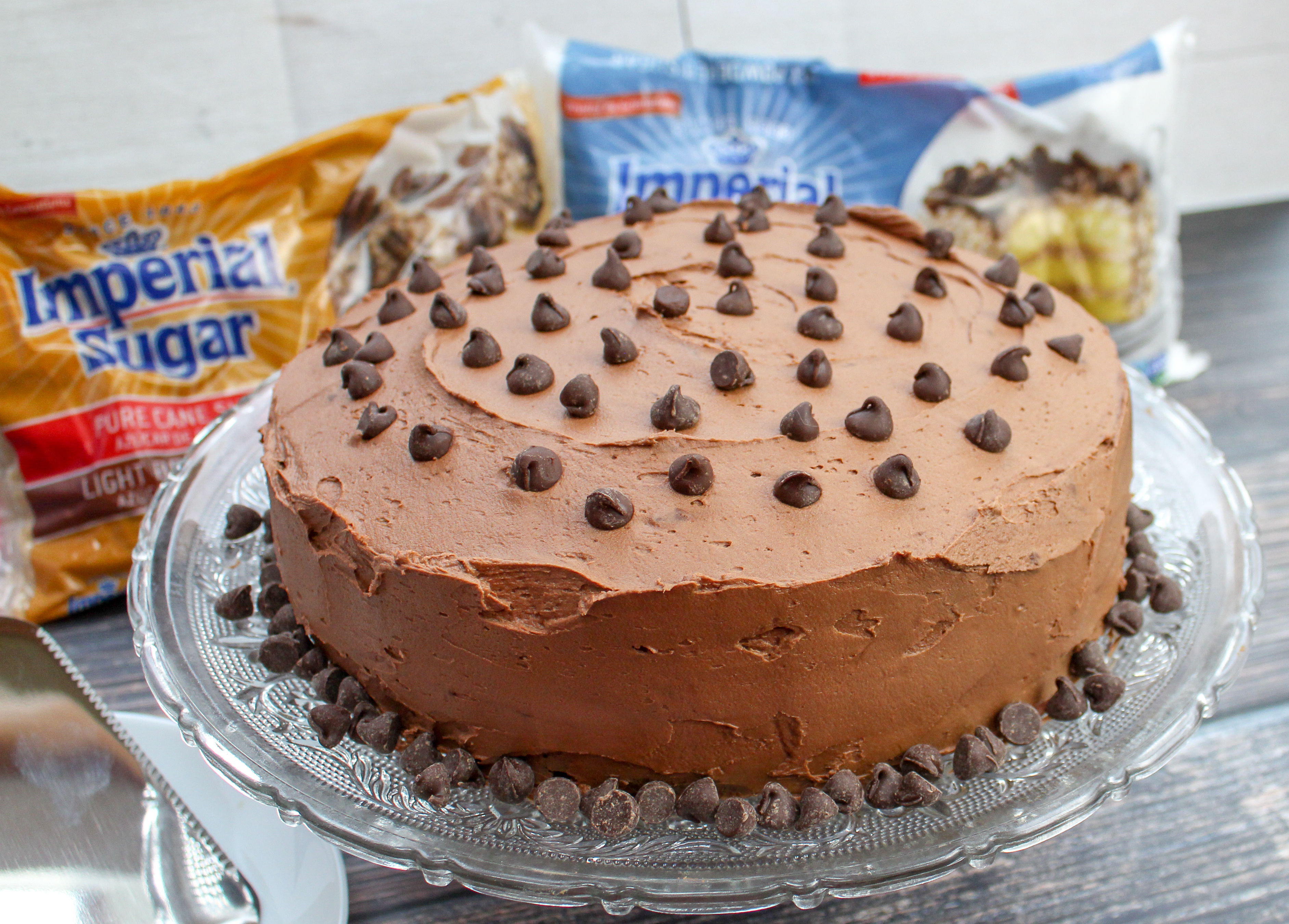 Full round cake with chocolate buttercream and topped with chocolate chips