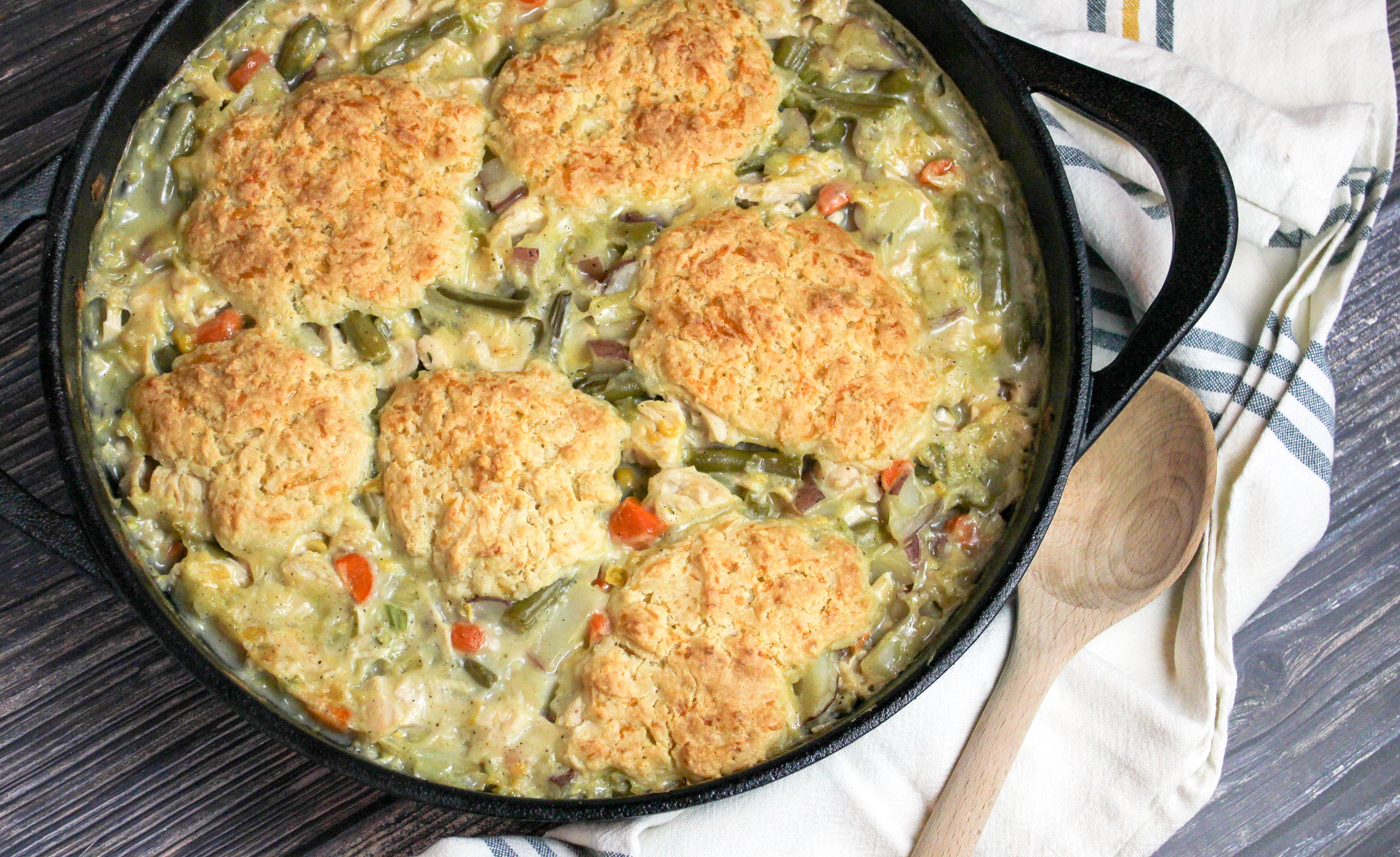 Creamy turkey shredded and baked with biscuits in a cast iron baking dish