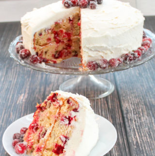 Cake topped with cranberries on a platter