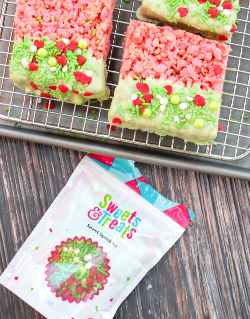 rice krispie treat squares dipped in white chocolate and sprinkles