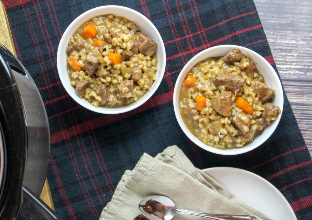White bowls filled with beef and barley stew