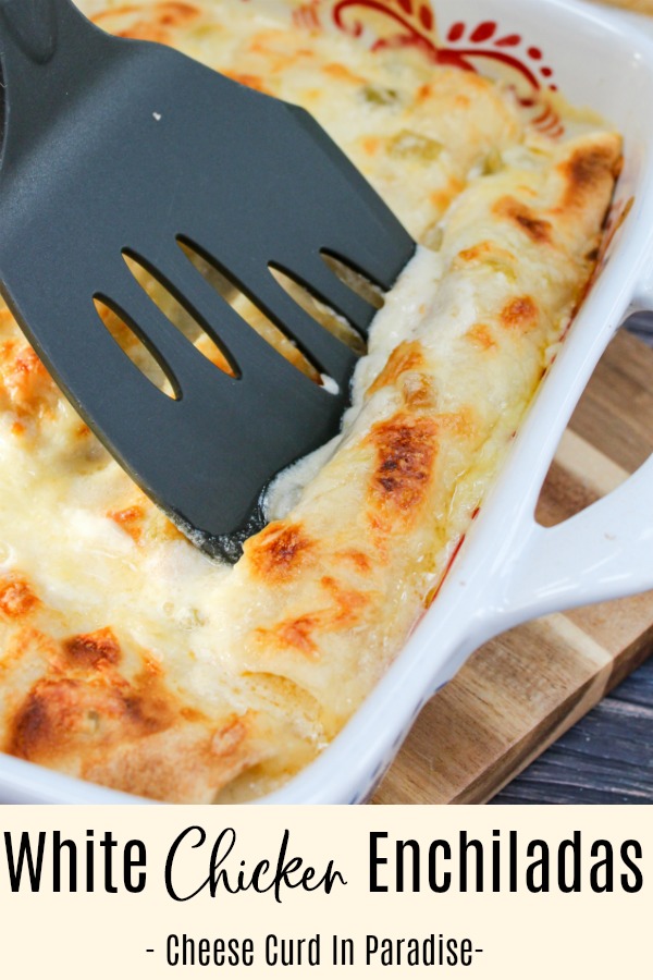 Chicken enchiladas in a pan with a spatula