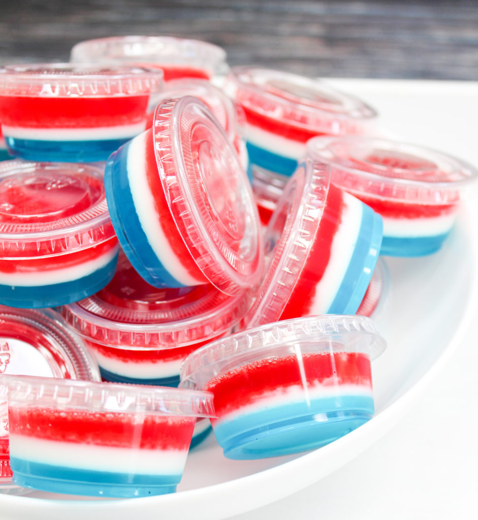 red white and blue jello shots in plastic containers