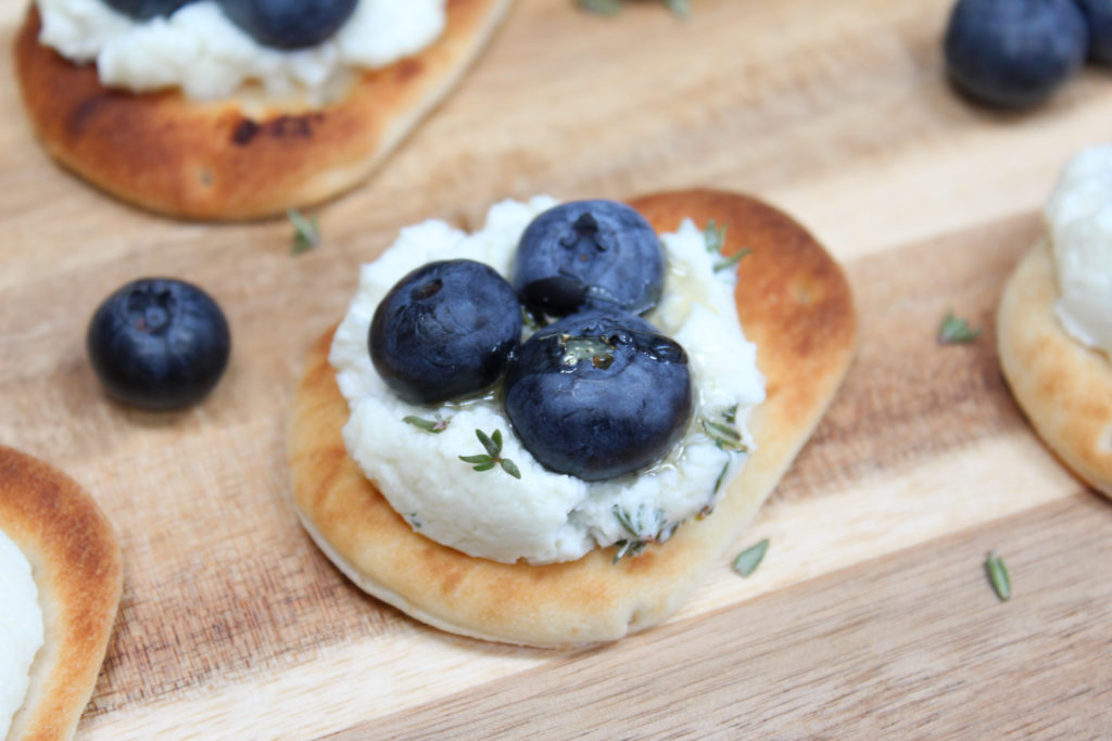 Naan with blueberries on a cutting board