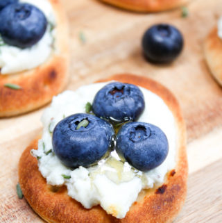 Naan with blueberries on a cutting board