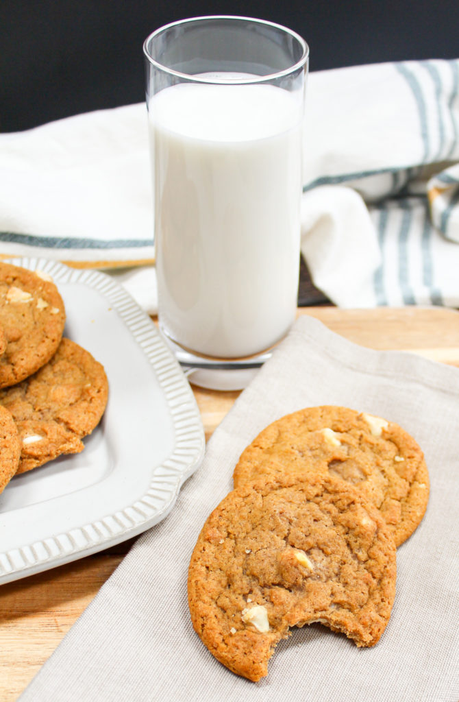 pumpkin cookies on a plate with milk