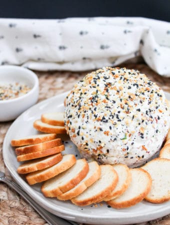 cheese ball on a plate with bagel chips around it