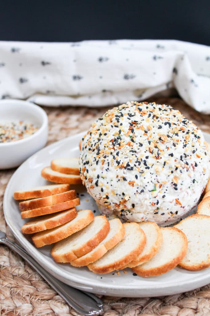 cheese ball on a plate with bagel chips around it