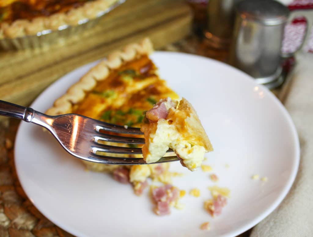 Ham and Cheese Quiche on a plate with a fork