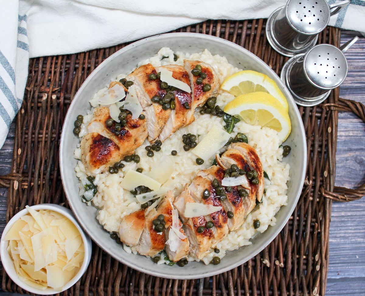 chicken risotto in a bowl with lemon