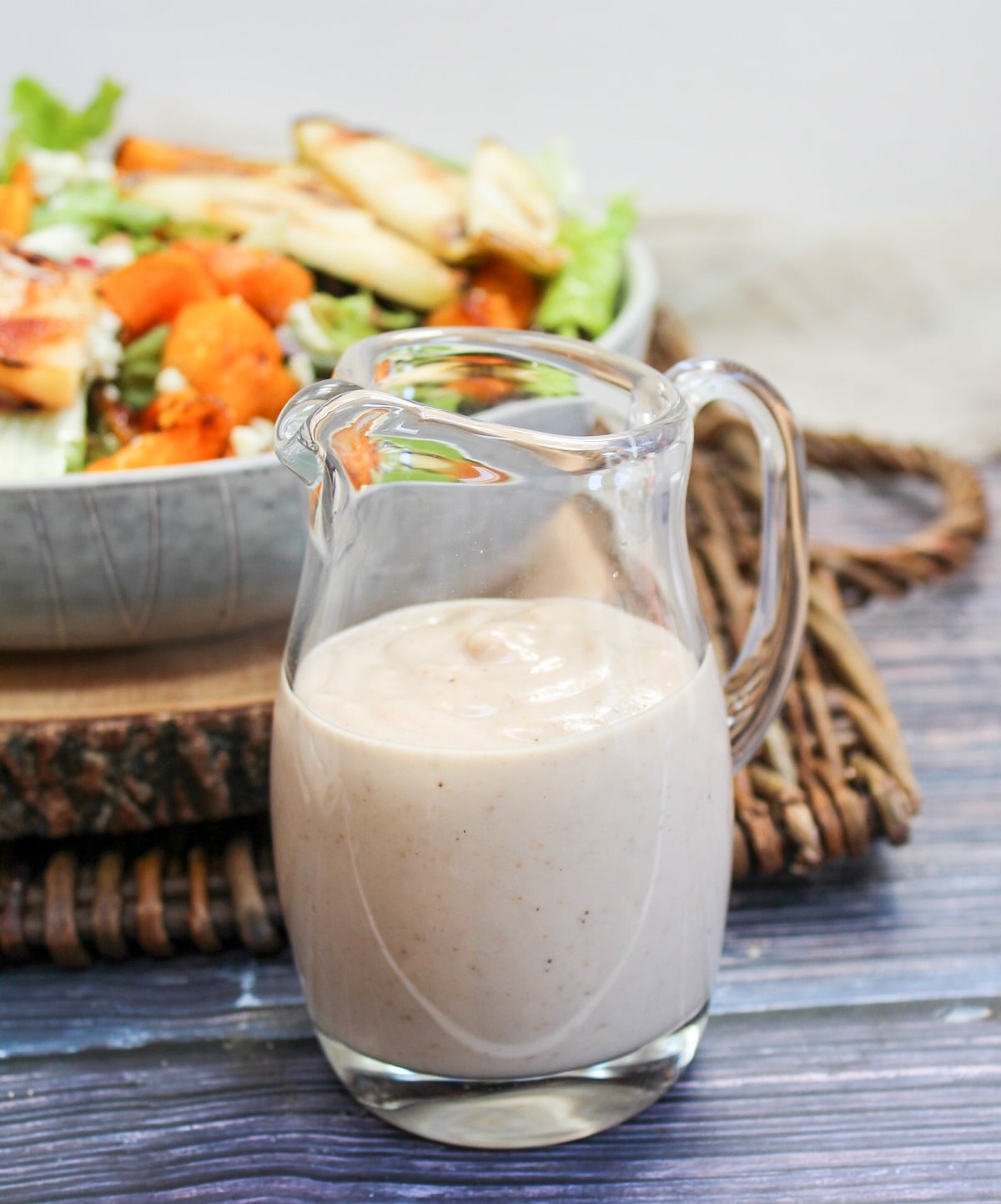 maple walnut dressing is a serving glass