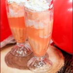ice cream float in a glass with whipped cream and a cherry