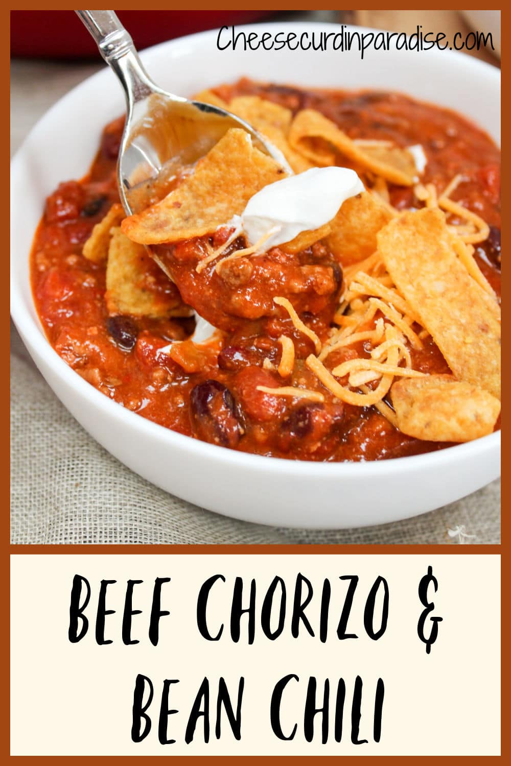 chili in a bowl with corn chips and spoon