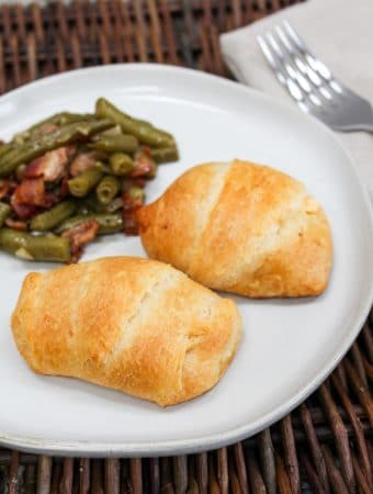 plated chicken crescent with green beans on the side